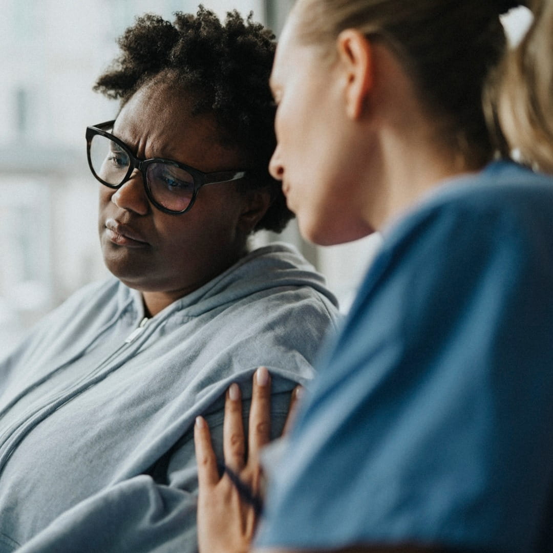 Health worker comforting patient