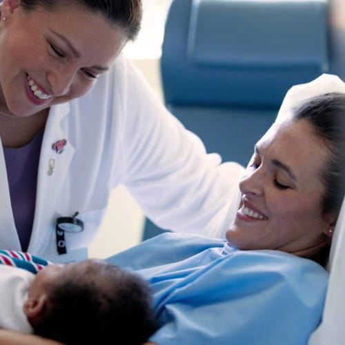 Physician, mother and newborn baby