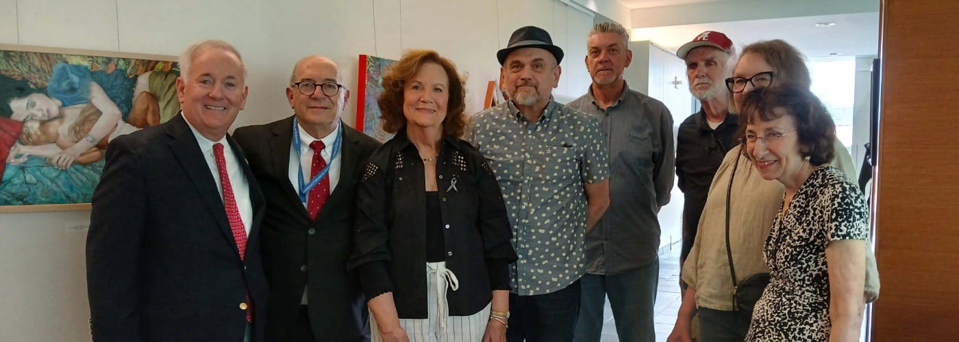 Jack Lynch with artists at the Ripples of Impact Art Exhibit