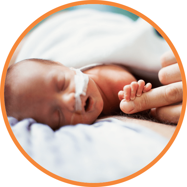 Premature baby holding parent's finger in NICU