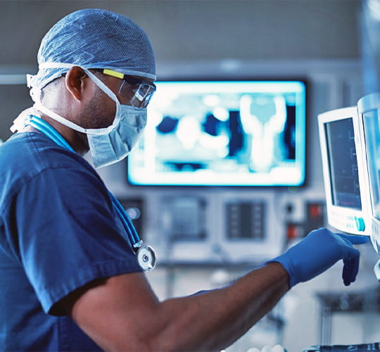 Surgeon checking vitals on screen
