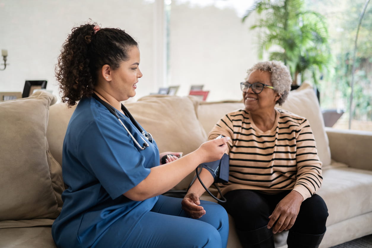 HomeCare nurse using blood pressure cuff on patient