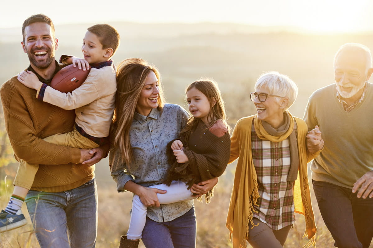 Happy multi-generation family taking a walk in nature.