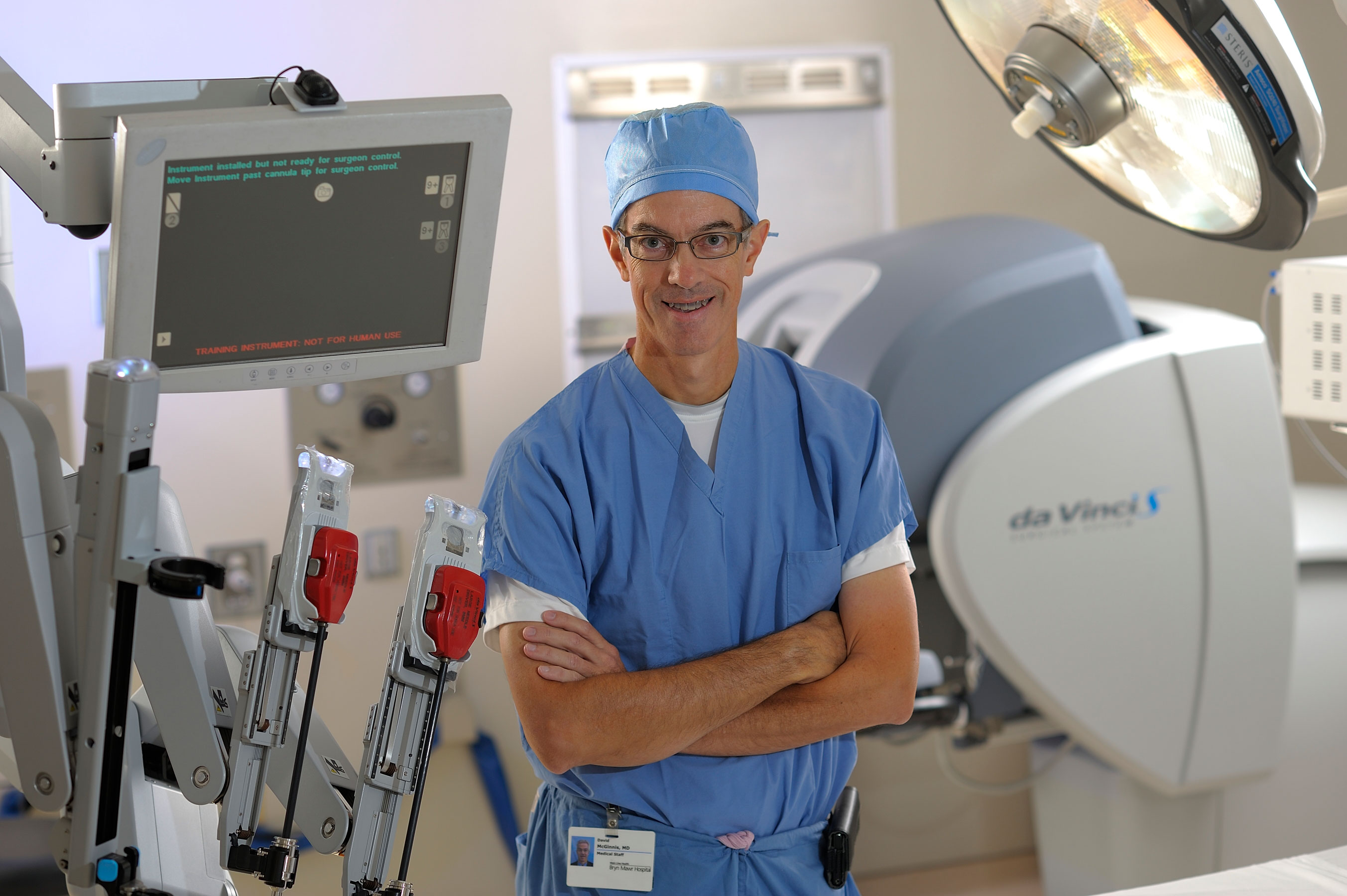David McGinnis, MD in front of daVinci surgical robot